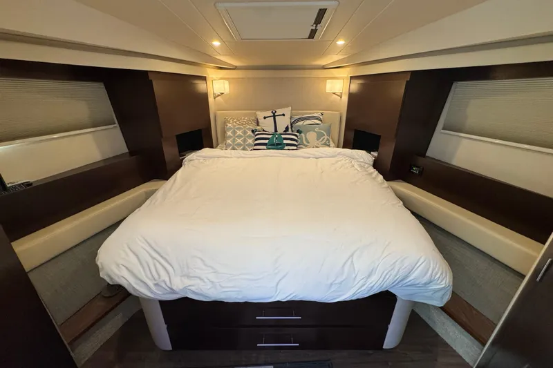 Blue Skies Yacht Photos Pics Luxurious bedroom interior of 2017 Regal 42 Fly yacht with cozy bedding and ambient lighting.