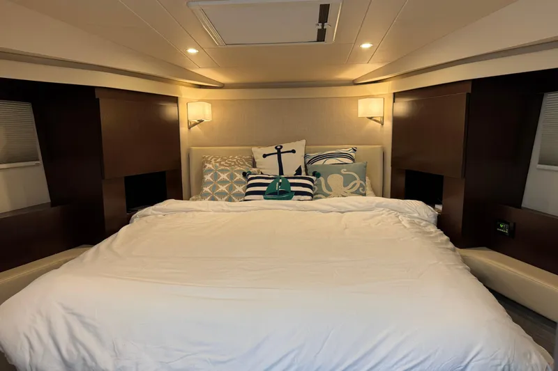 Blue Skies Yacht Photos Pics Luxurious bedroom interior of 2017 Regal 42 Fly yacht with nautical-themed pillows.