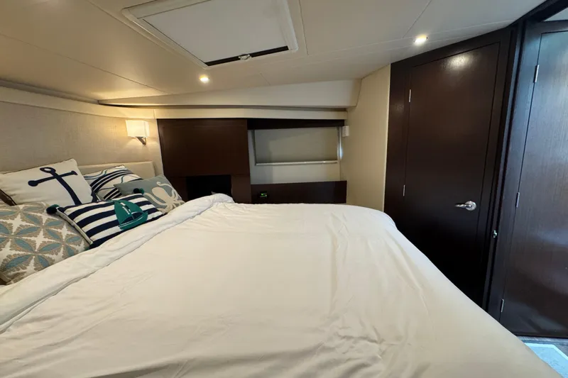 Blue Skies Yacht Photos Pics Luxurious bedroom interior of 2017 Regal 42 Fly yacht with nautical-themed decor.