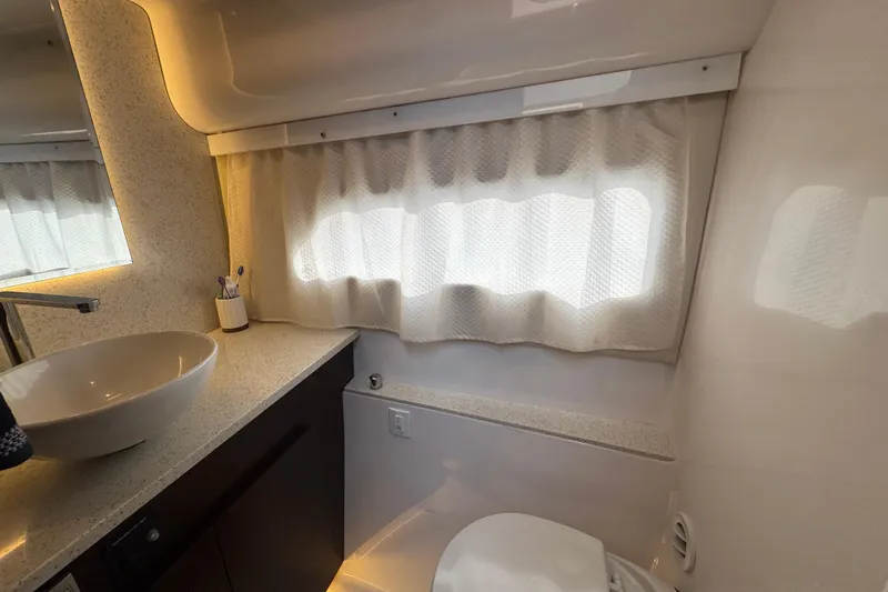 Blue Skies Yacht Photos Pics Luxurious bathroom interior of 2017 Regal 42 Fly yacht with modern fixtures.