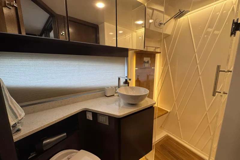 Blue Skies Yacht Photos Pics Luxurious bathroom in 2017 Regal 42 Fly yacht with modern fixtures and elegant design.