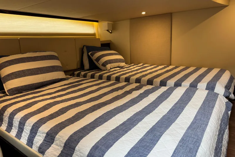 Blue Skies Yacht Photos Pics Interior of 2017 Regal 42 Fly yacht with striped twin beds.