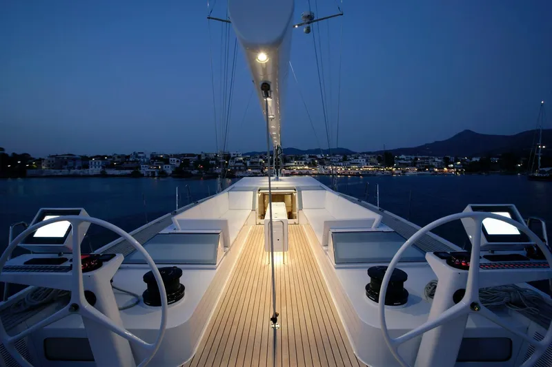 Polytropon II Yacht Photos Pics Luxurious 2008 Nautor Swan 82 yacht deck at dusk, featuring elegant design and serene waterfront view.