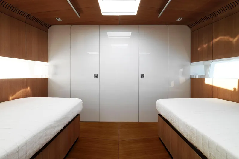 Polytropon II Yacht Photos Pics Luxurious cabin interior of 2008 Nautor Swan 82 yacht with twin beds and sleek wood finish.