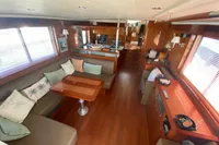 Luxurious interior of 2011 Beneteau Swift Trawler 52 with elegant wood finishes and cozy seating.