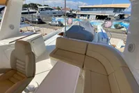 Luxurious seating area on a 2011 Beneteau Swift Trawler 52 yacht, docked at a marina.