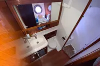 Bathroom interior of 2011 Beneteau Swift Trawler 52, featuring sink, toilet, and shower.