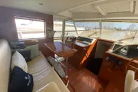 Interior of 2011 Beneteau Swift Trawler 52 with seating and helm station.