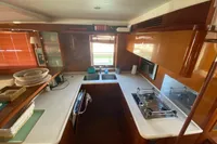 2011 Beneteau Swift Trawler 52 kitchen with modern appliances and wooden cabinetry.