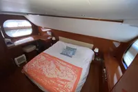 Luxurious bedroom interior of 2011 Beneteau Swift Trawler 52 with elegant wood finish.