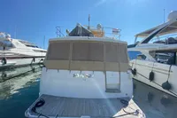 2011 Beneteau Swift Trawler 52 docked at marina under clear blue sky.