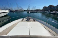 Bow view of 2011 Beneteau Swift Trawler 52 docked in a marina.