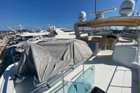 2011 Beneteau Swift Trawler 52 docked, showcasing spacious deck and covered seating area.