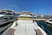 2011 Beneteau Swift Trawler 52 docked at marina under clear blue sky.