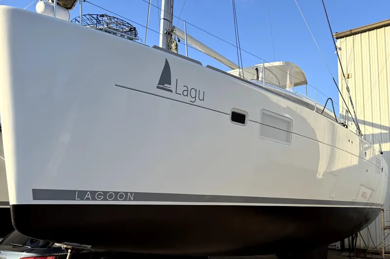 "lagu" Yacht Photos Pics 2011 Lagoon 450 catamaran docked, showcasing sleek design and branding.
