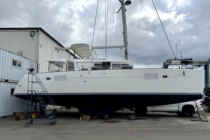 "lagu" Yacht Photos Pics Lagoon 450 catamaran from 2011 on dry dock, with overcast sky background.