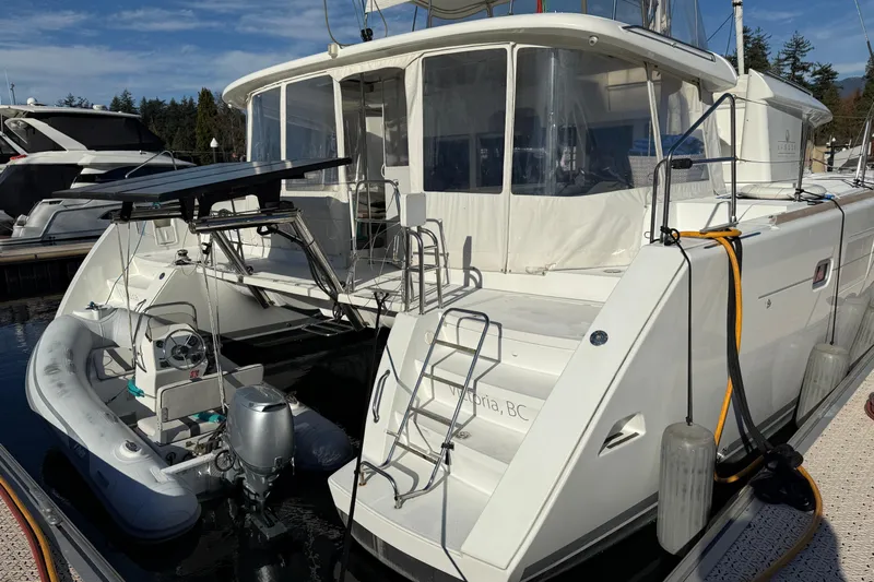 "lagu" Yacht Photos Pics 2012 Lagoon 450 catamaran docked with inflatable dinghy and outboard motor.