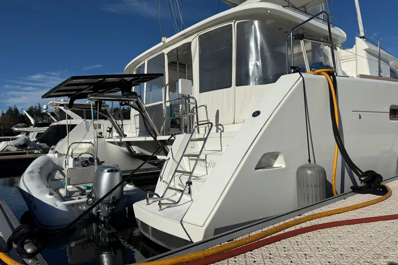 "lagu" Yacht Photos Pics 2012 Lagoon 450 catamaran docked with inflatable boat and clear blue sky.