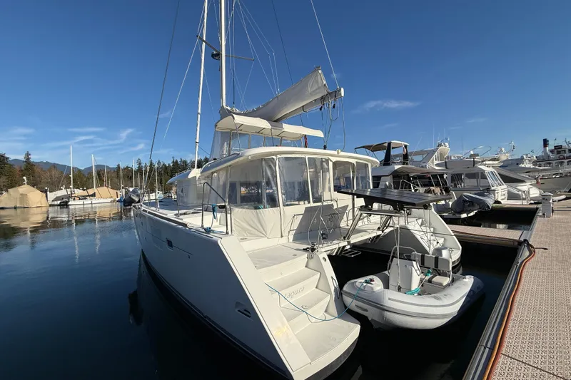 "lagu" Yacht Photos Pics 2012 Lagoon 450 catamaran docked at marina under clear blue sky.