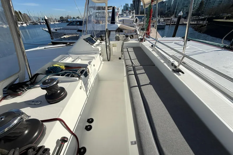 "lagu" Yacht Photos Pics 2012 Lagoon 450 catamaran deck with seating, winches, and marina view.