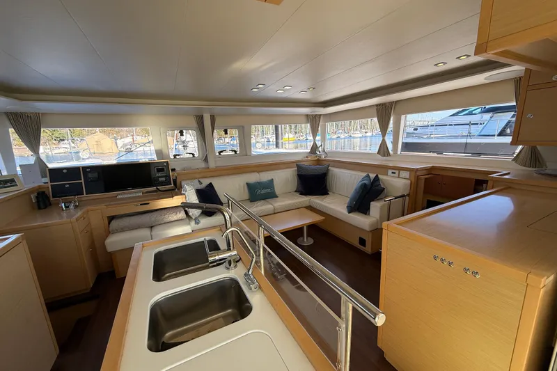"lagu" Yacht Photos Pics Luxurious interior of a 2012 Lagoon 450 catamaran with modern kitchen and spacious seating area.