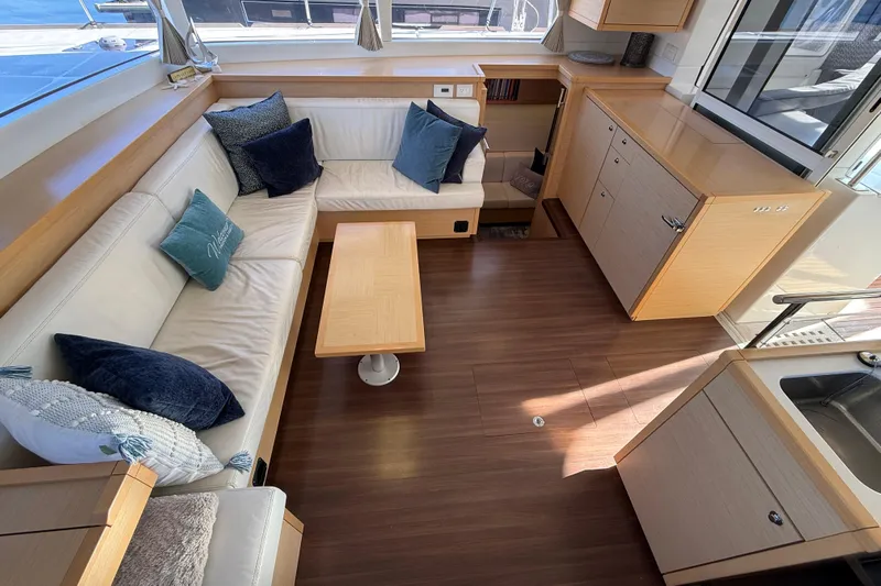 "lagu" Yacht Photos Pics Interior of 2012 Lagoon 450 yacht with modern seating and wooden cabinetry.