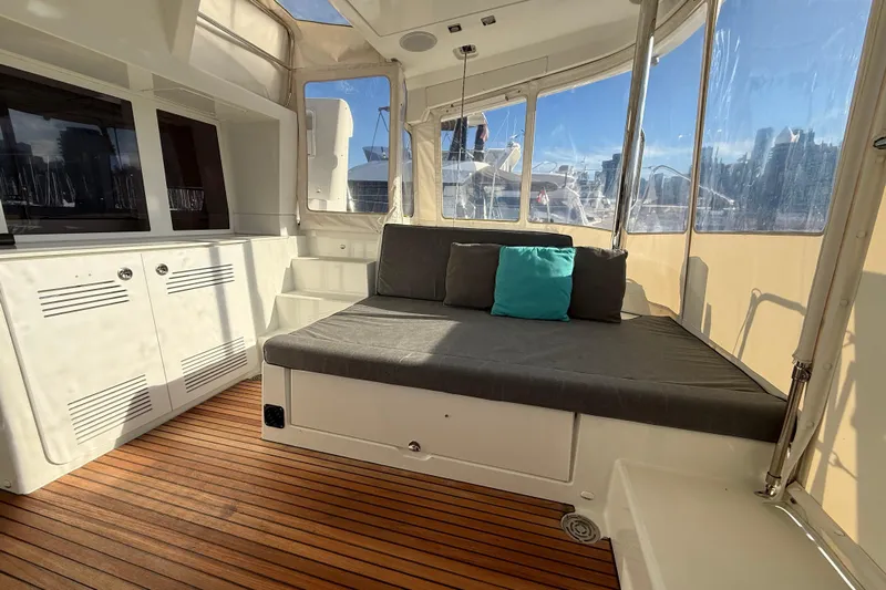 "lagu" Yacht Photos Pics Interior of 2012 Lagoon 450 catamaran with cozy seating and wooden flooring.