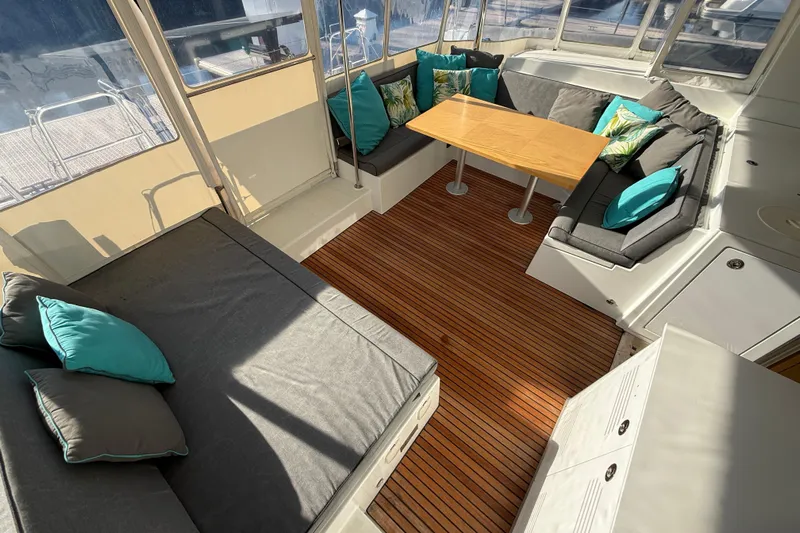 "lagu" Yacht Photos Pics Spacious interior of 2012 Lagoon 450 catamaran with cushioned seating and wooden flooring.