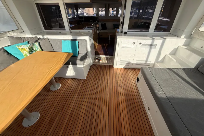 "lagu" Yacht Photos Pics Interior of 2012 Lagoon 450 catamaran with wooden flooring and cozy seating area.