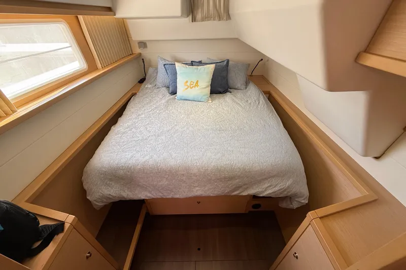 "lagu" Yacht Photos Pics Cozy bedroom in 2012 Lagoon 450 yacht with nautical-themed decor.
