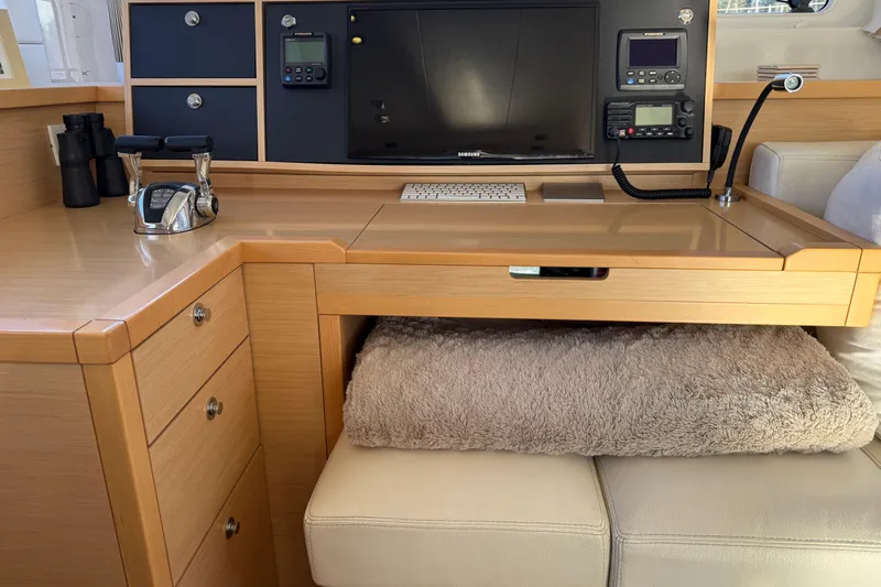 "lagu" Yacht Photos Pics Interior of a 2012 Lagoon 450 yacht with navigation equipment and cozy seating.
