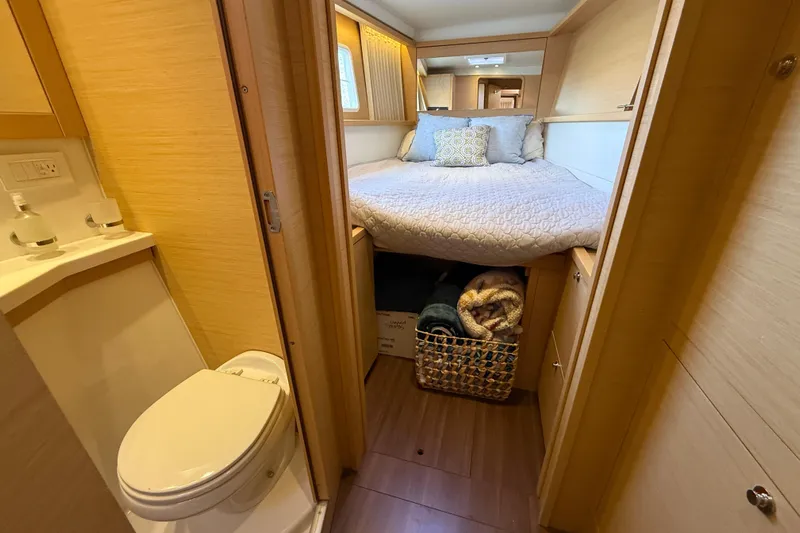 "lagu" Yacht Photos Pics Interior of 2012 Lagoon 450 yacht featuring cozy bedroom and compact bathroom.