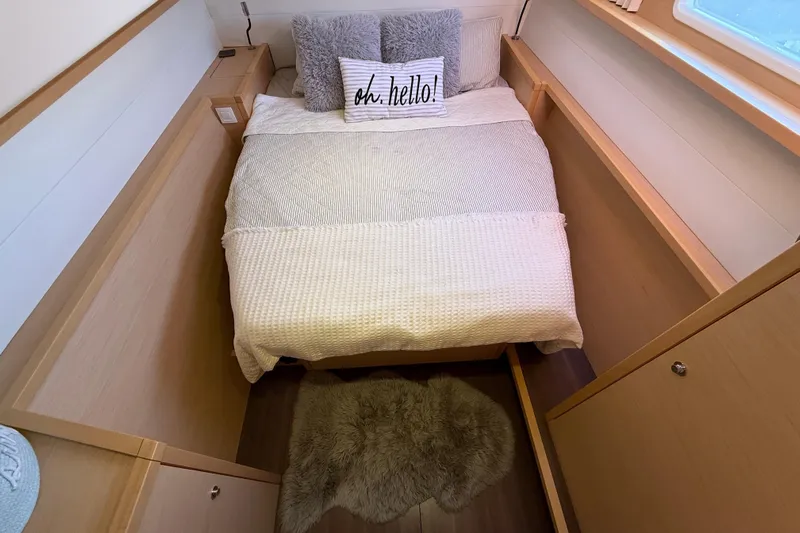 "lagu" Yacht Photos Pics Cozy bedroom in 2012 Lagoon 450 yacht with plush bedding and decorative pillows.