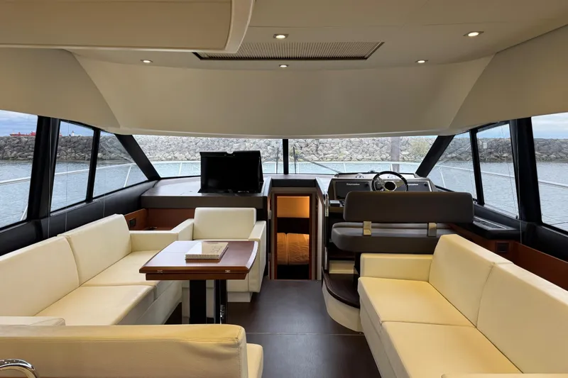  Yacht Photos Pics Luxurious interior of 2013 Prestige 500 yacht with elegant seating and panoramic windows.