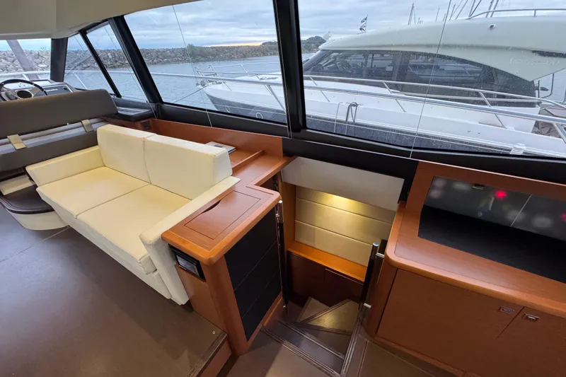  Yacht Photos Pics Interior of 2013 Prestige 500 yacht with white seating and wooden accents.