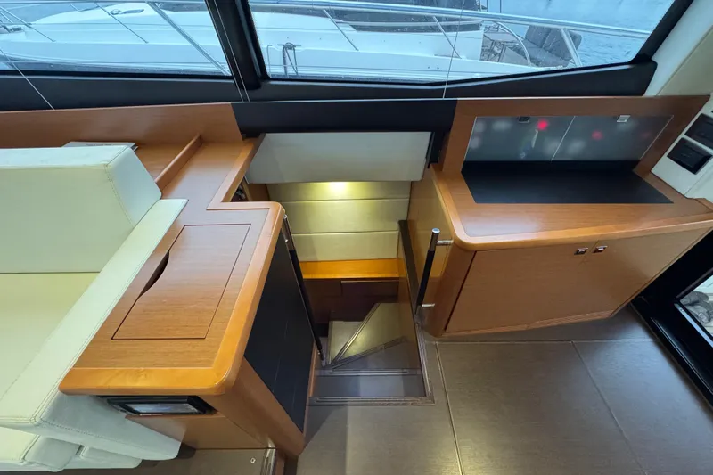  Yacht Photos Pics Interior of 2013 Prestige 500 yacht, featuring wooden cabinetry and stairs leading below deck.