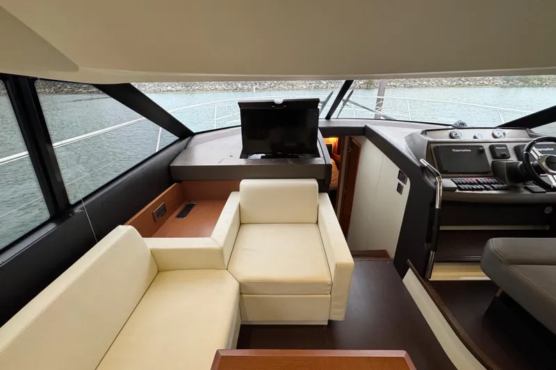  Yacht Photos Pics Luxurious interior of a 2013 Prestige 500 yacht with modern seating and navigation equipment.