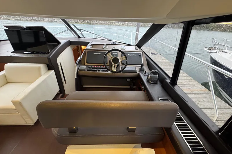  Yacht Photos Pics Interior view of a 2013 Prestige 500 yacht helm with modern navigation equipment.