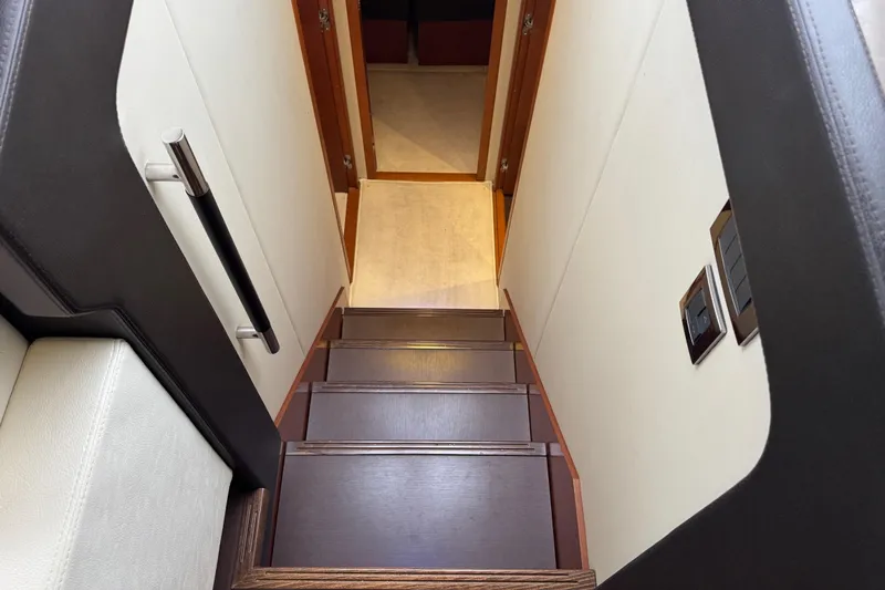  Yacht Photos Pics Staircase inside 2013 Prestige 500 yacht, featuring sleek wooden steps and modern design.