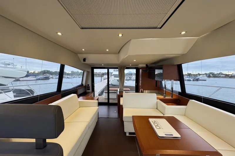  Yacht Photos Pics Luxurious interior of a 2013 Prestige 500 yacht with elegant seating and panoramic windows.
