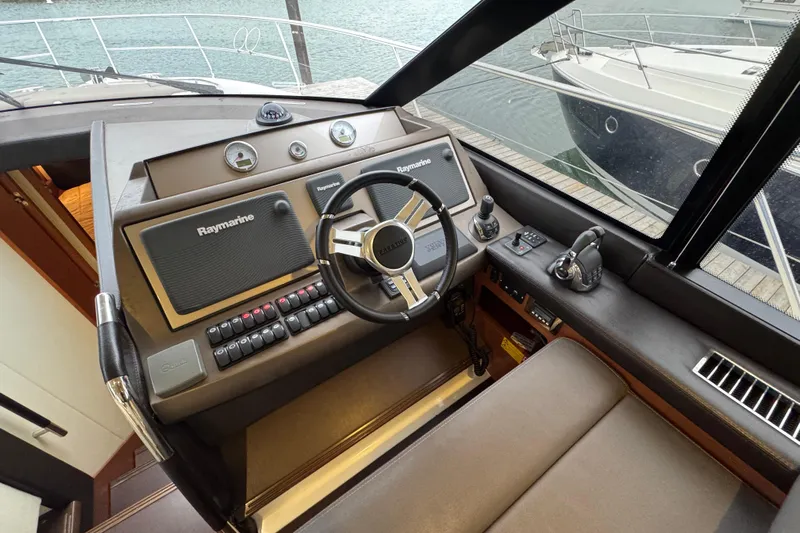  Yacht Photos Pics Helm of 2013 Prestige 500 yacht with Raymarine navigation system and steering wheel.