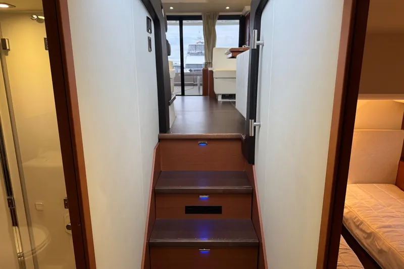  Yacht Photos Pics Interior of 2013 Prestige 500 yacht, featuring wooden stairs and modern design elements.