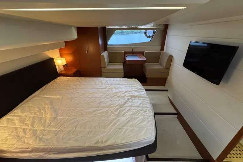  Yacht Photos Pics Luxurious cabin interior of 2013 Prestige 500 yacht with bed, seating, and TV.