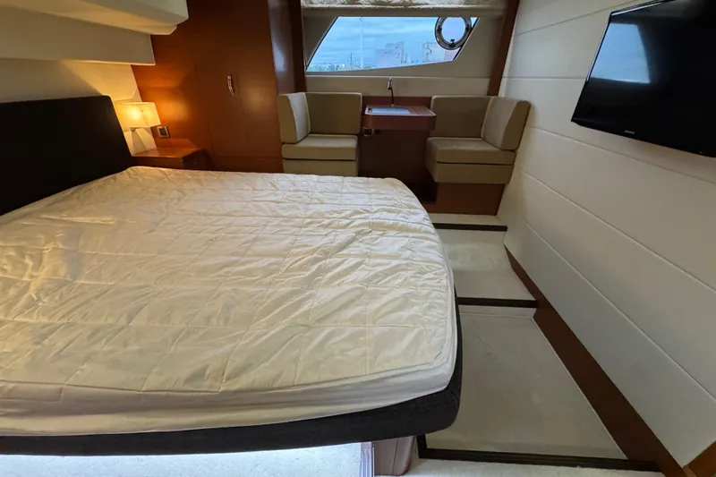  Yacht Photos Pics Luxurious 2013 Prestige 500 yacht bedroom with bed, seating, and TV.