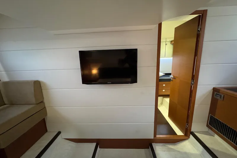  Yacht Photos Pics Interior of 2013 Prestige 500 yacht with TV and open door to cabin.
