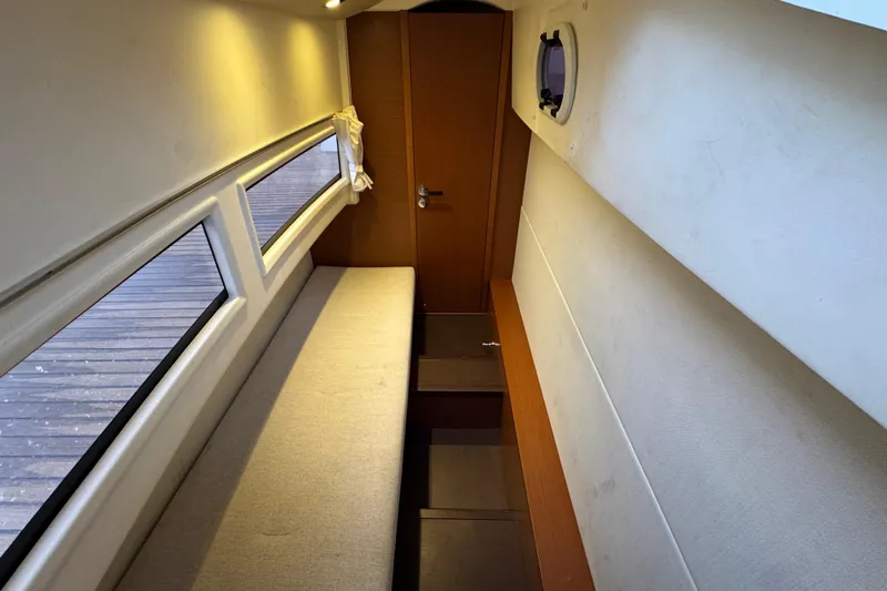  Yacht Photos Pics Interior of 2013 Prestige 500 yacht with cozy seating and porthole window.