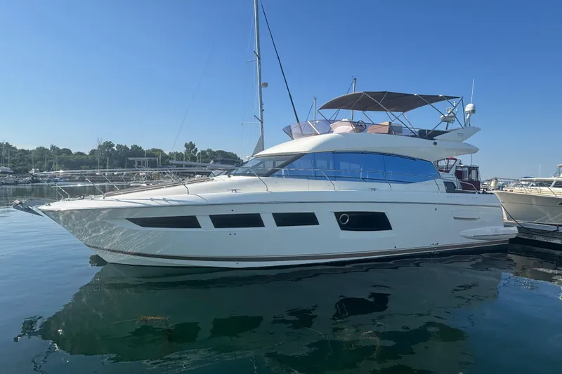  Yacht Photos Pics 2013 Prestige 500 yacht docked in a marina under clear blue skies.