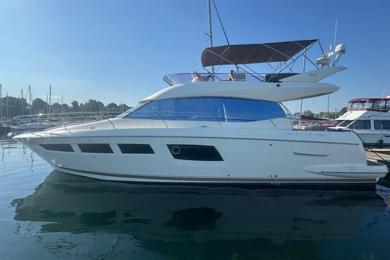  Yacht Photos Pics 2013 Prestige 500 yacht docked in a marina under clear blue skies.