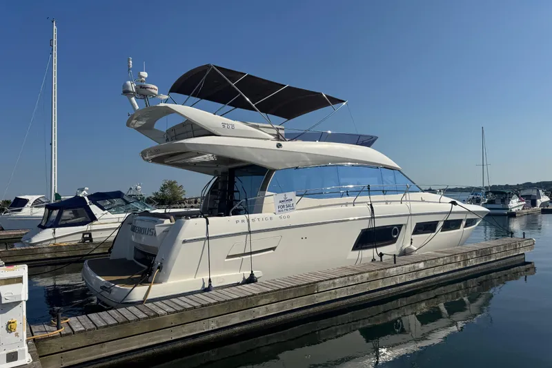  Yacht Photos Pics Luxury 2013 Prestige 500 yacht docked at marina under clear blue sky.