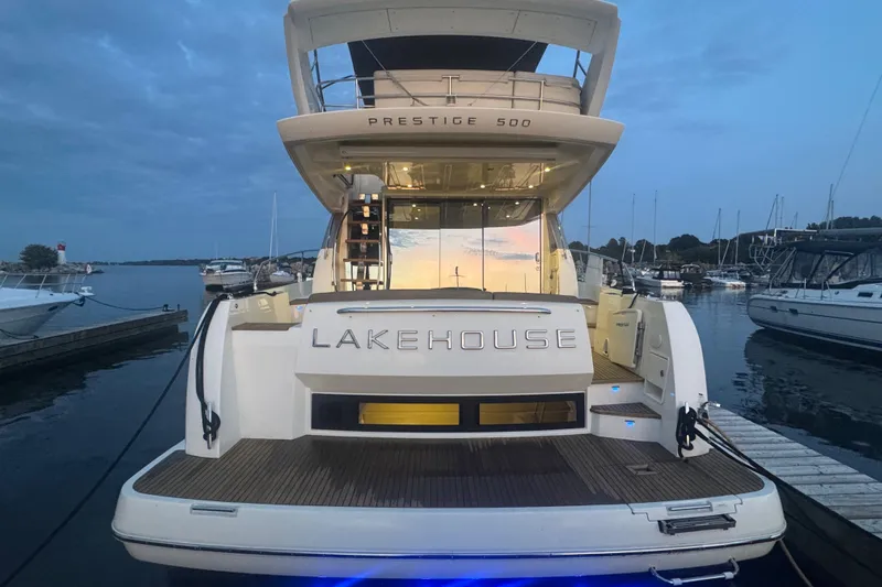  Yacht Photos Pics Luxury 2013 Prestige 500 yacht named "Lakehouse" docked at marina during sunset.